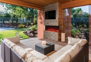 Outdoor living area complete with three-sided electric fireplace from Amantii brand