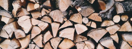 A stack of dried and seasoned firewood, ready for use in a wood burning fireplace.