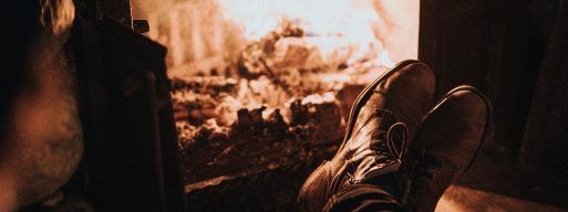 Man enjoys a warm wood burning fireplace
